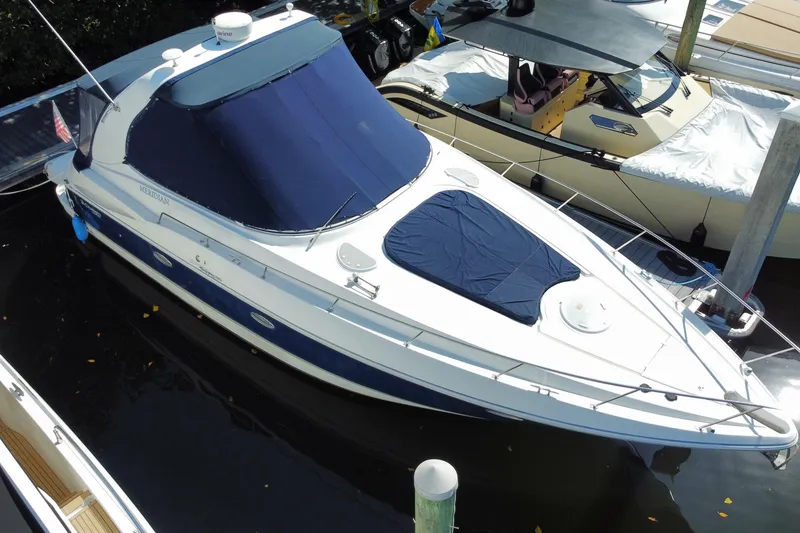 Slide: The Image of 2007 Cruisers Yachts 370 Express docked, featuring blue covers and sleek design. - 12