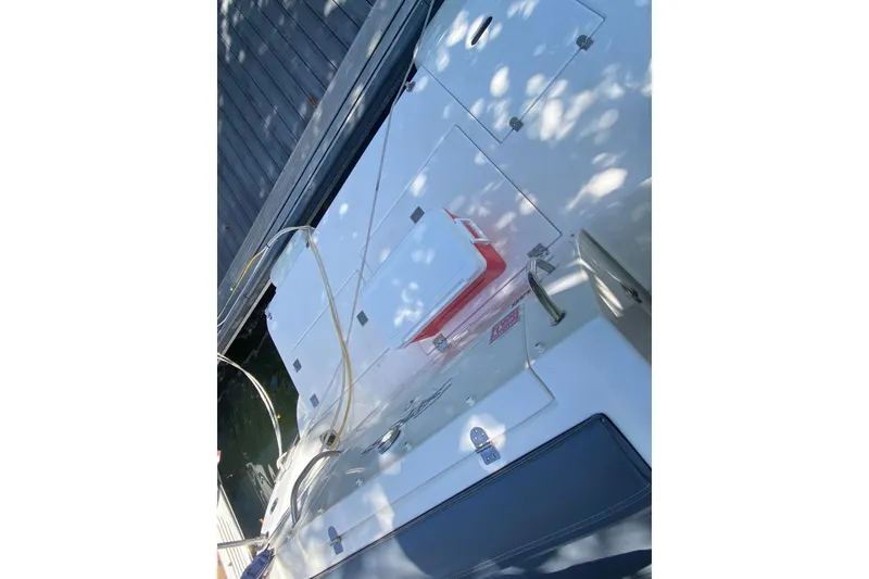 Slide: The Image of 2007 Cruisers Yachts 370 Express deck with storage compartments and cooler. - 20