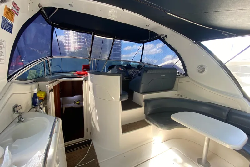 Slide: The Image of 2007 Cruisers Yachts 370 Express interior with helm, seating, and sink. - 22
