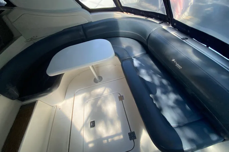 Slide: The Image of 2007 Cruisers Yachts 370 Express interior with curved seating and table. - 23