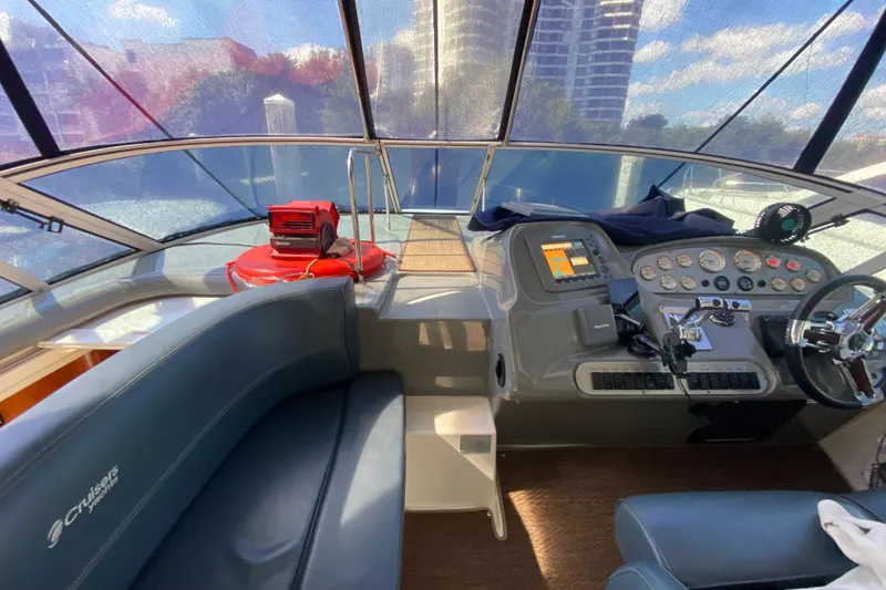 Slide: The Image of 2007 Cruisers Yachts 370 Express helm with modern controls and comfortable seating. - 29