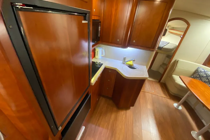 Slide: The Image of 2007 Cruisers Yachts 370 Express interior with kitchenette and seating area. - 39