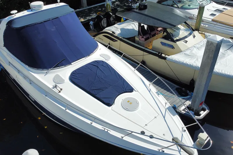 Slide: The Image of 2007 Cruisers Yachts 370 Express docked, featuring sleek design and blue covers. - 4