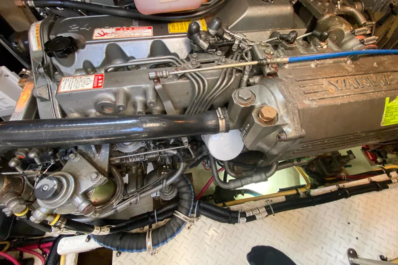 Slide: The Image of Engine compartment of a 2007 Cruisers Yachts 370 Express, showcasing mechanical components and wiring. - 54