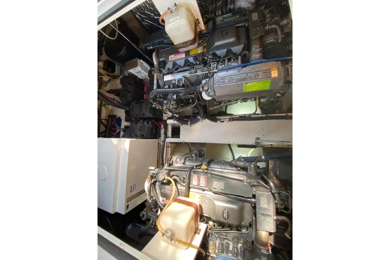 Slide: The Image of Engine compartment of 2007 Cruisers Yachts 370 Express, showcasing Yanmar engines and components. - 60