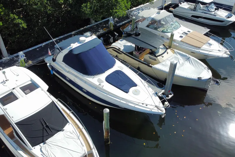 The Image of 2007 Cruisers Yachts 370 Express docked among other boats in a marina. - 1