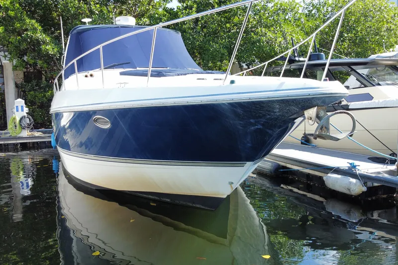 Slide: The Image of 2007 Cruisers Yachts 370 Express docked, featuring sleek design and blue hull. - 13