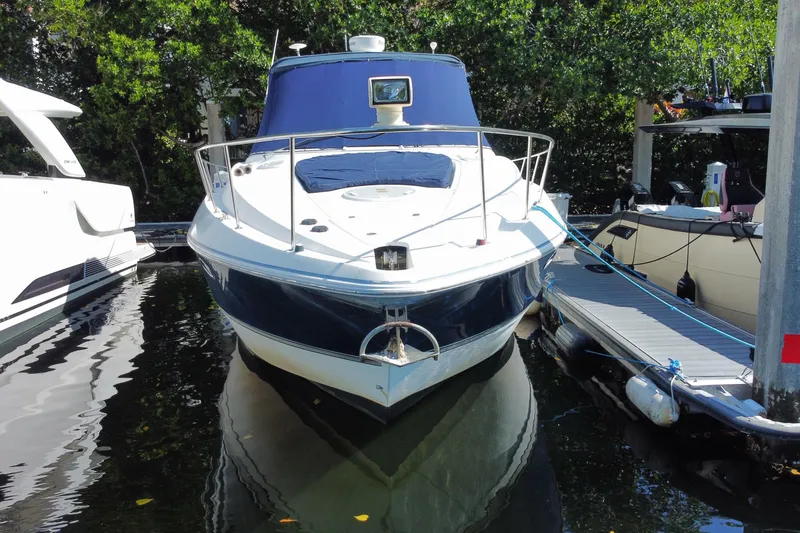 Slide: The Image of 2007 Cruisers Yachts 370 Express docked, surrounded by lush greenery. - 15