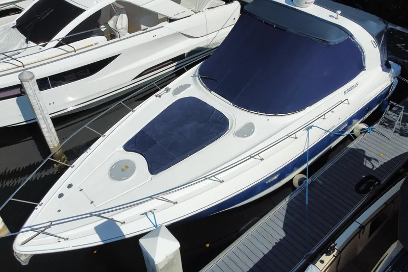 Slide: The Image of 2007 Cruisers Yachts 370 Express docked, featuring sleek design and blue covers. - 17