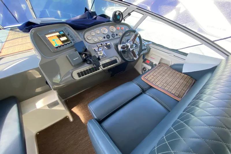 Slide: The Image of 2007 Cruisers Yachts 370 Express helm with navigation controls and leather seating. - 28