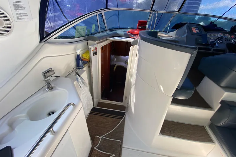 Slide: The Image of 2007 Cruisers Yachts 370 Express interior with helm, sink, and cabin entrance. - 35