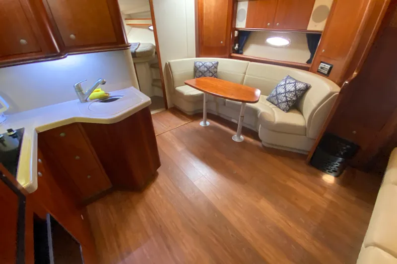 Slide: The Image of 2007 Cruisers Yachts 370 Express interior with kitchenette and cozy seating area. - 37