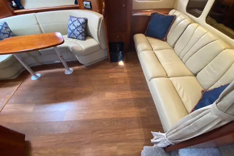 Slide: The Image of Interior of 2007 Cruisers Yachts 370 Express with beige seating and wooden table. - 38
