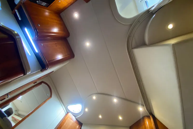 Slide: The Image of Interior view of 2007 Cruisers Yachts 370 Express, featuring elegant wood cabinetry and modern lighting. - 42