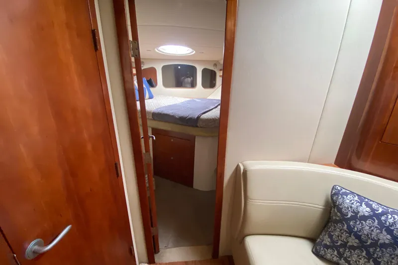 Slide: The Image of Interior of 2007 Cruisers Yachts 370 Express, featuring cozy cabin and elegant wood finishes. - 44