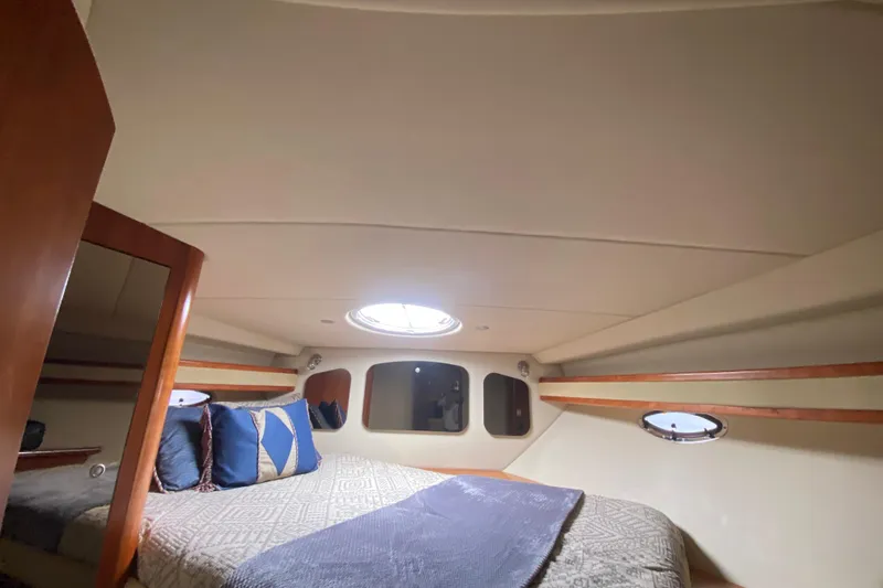 Slide: The Image of Luxurious cabin interior of 2007 Cruisers Yachts 370 Express with cozy bedding. - 46