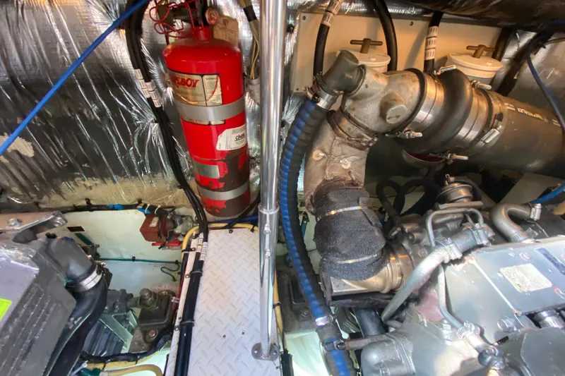 Slide: The Image of Engine room of 2007 Cruisers Yachts 370 Express with fire extinguisher and mechanical components. - 57