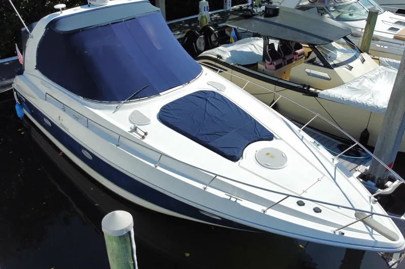 Slide: The Image of 2007 Cruisers Yachts 370 Express docked, featuring sleek design and blue covers. - 8