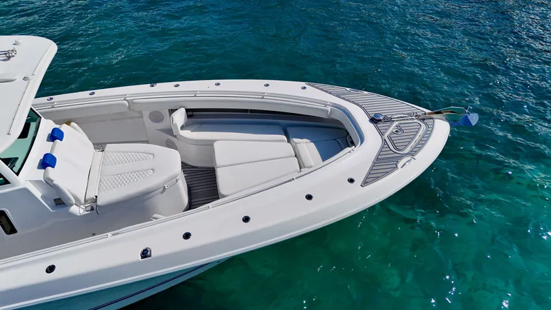 Slide: The Image of 2019 HCB 42 Siesta boat with white seating on clear blue water. - 21