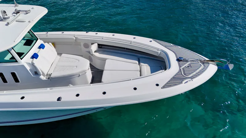 Slide: The Image of 2019 HCB 42 Siesta boat on clear blue water, showcasing sleek design and spacious deck. - 22