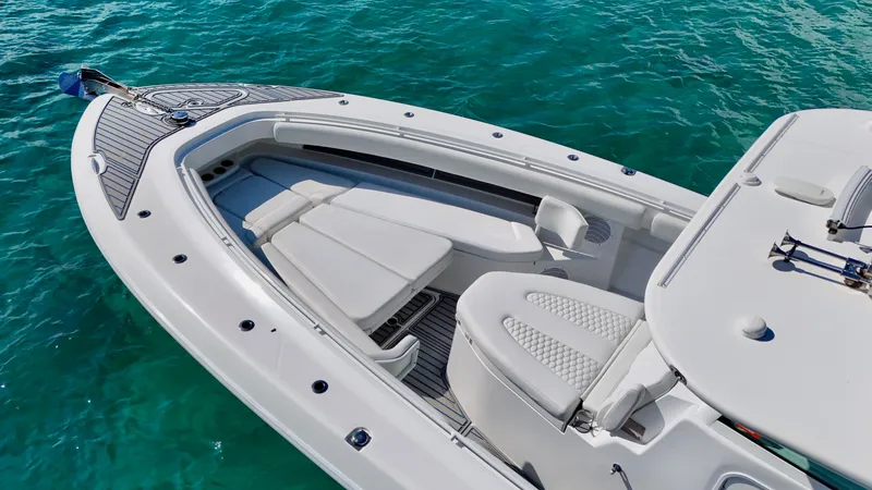 Slide: The Image of 2019 HCB 42 Siesta boat with sleek deck design on clear blue water. - 24