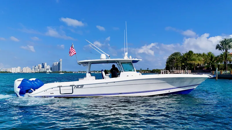 Slide: The Image of 2019 HCB 42 Siesta boat cruising on blue water near a city skyline. - 29