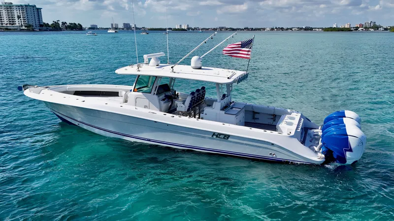 Slide: The Image of 2019 HCB 42 Siesta boat on clear blue water with American flag. - 34