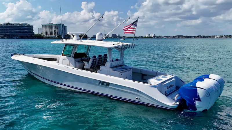 Slide: The Image of 2019 HCB 42 Siesta boat on clear blue water with American flag. - 35