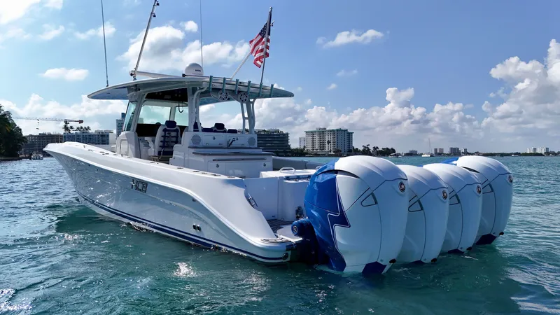 Slide: The Image of 2019 HCB 42 Siesta boat with four engines on clear blue water. - 37