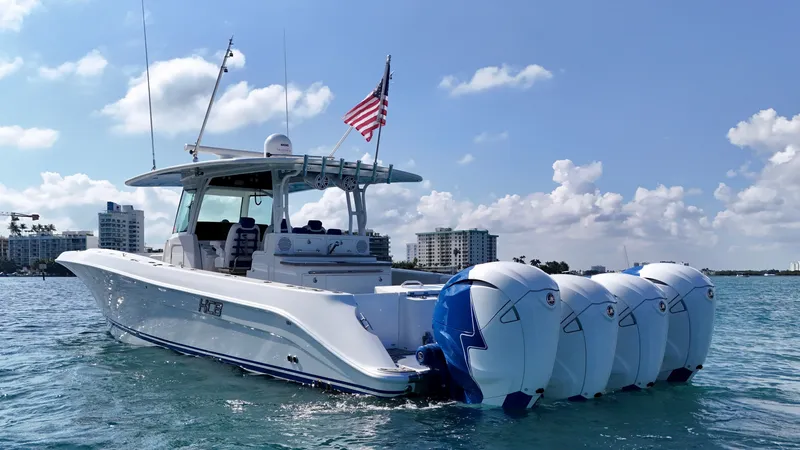 Slide: The Image of 2019 HCB 42 Siesta boat with four engines on water, American flag flying. - 39