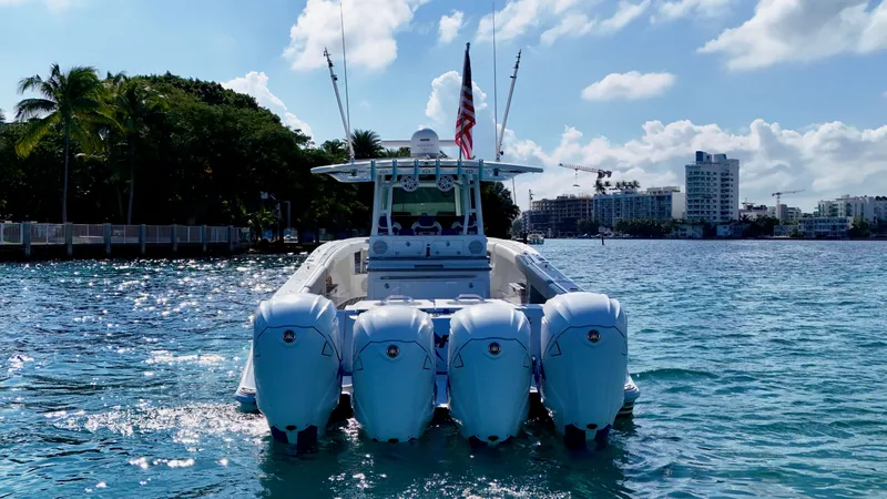 Slide: The Image of 2019 HCB 42 Siesta boat with four engines on a sunny waterfront. - 42