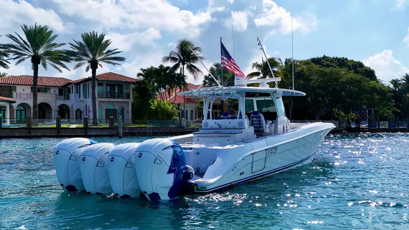 Slide: The Image of 2019 HCB 42 Siesta boat with multiple engines on a sunny waterfront. - 45