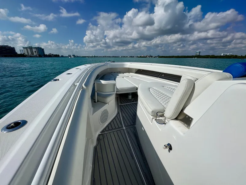 Slide: The Image of 2019 HCB 42 Siesta boat with luxurious seating on calm waters under a partly cloudy sky. - 48