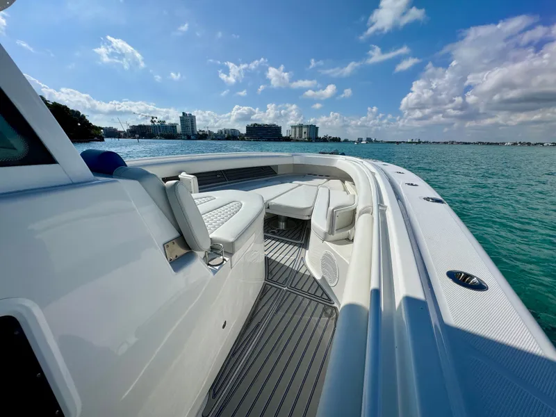 Slide: The Image of 2019 HCB 42 Siesta boat with luxurious seating, cruising on clear blue waters. - 50