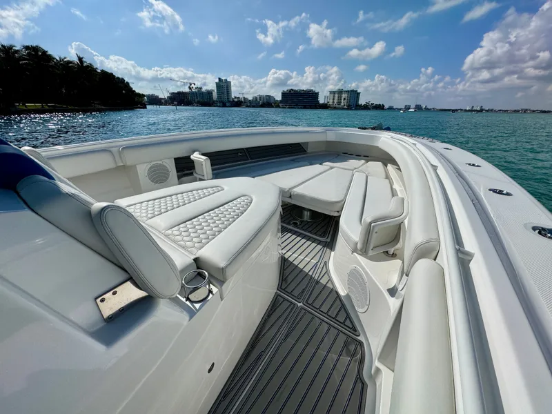 Slide: The Image of 2019 HCB 42 Siesta boat interior with luxurious seating, on a sunny day by the water. - 51