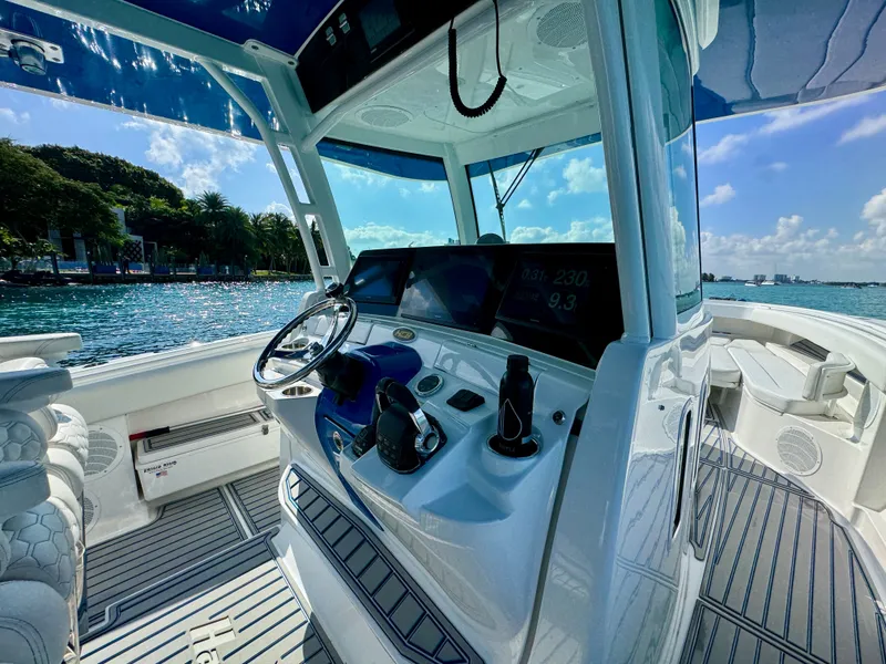 Slide: The Image of 2019 HCB 42 Siesta boat interior with modern helm, steering wheel, and ocean view. - 53