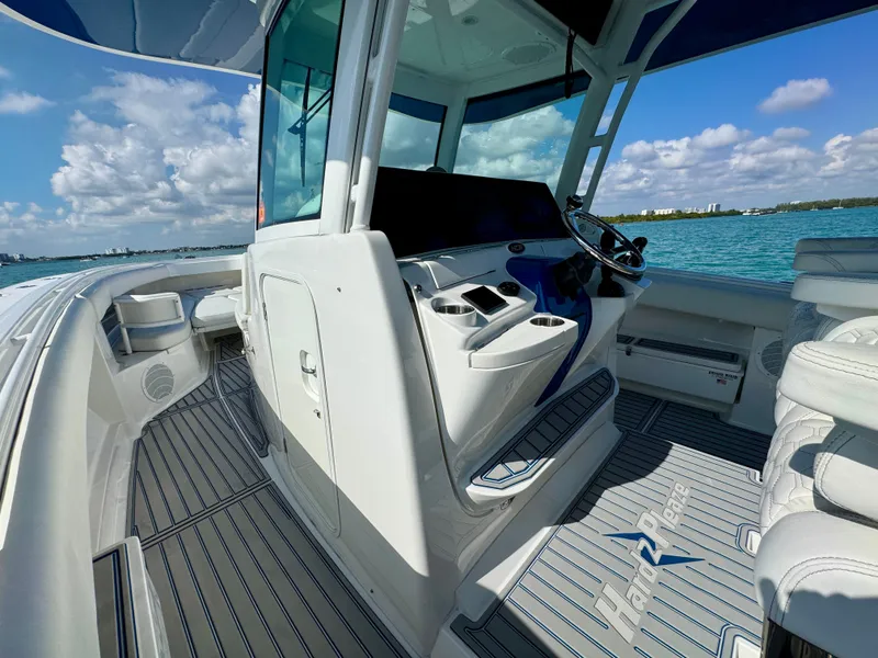 Slide: The Image of 2019 HCB 42 Siesta boat interior with helm, ocean view, and clear skies. - 58