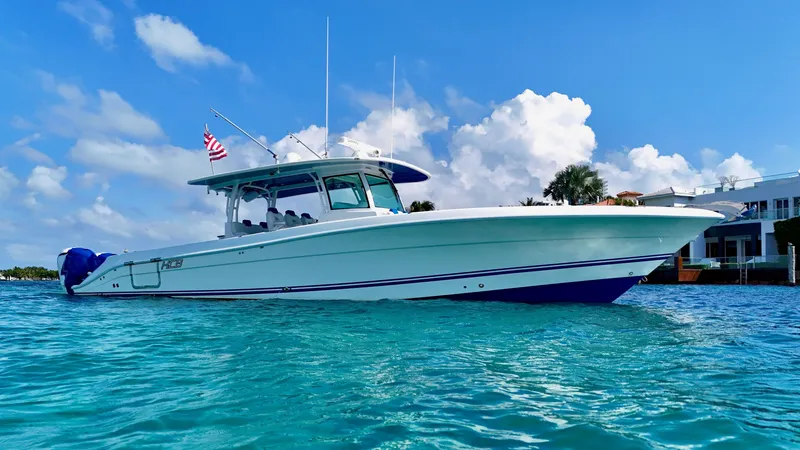 Slide: The Image of 2019 HCB 42 Siesta boat on clear blue water under a bright sky. - 6