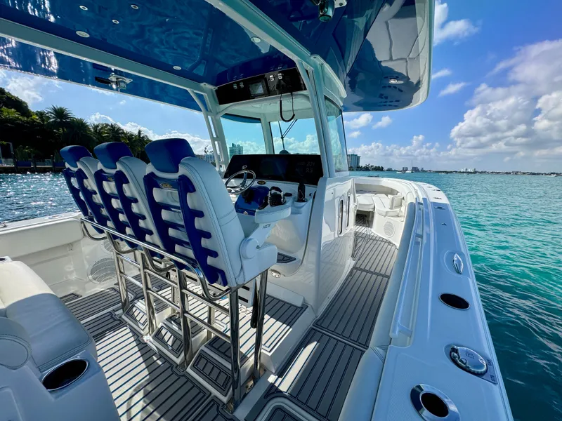 Slide: The Image of 2019 HCB 42 Siesta boat interior with blue seating, ocean view, and clear skies. - 62