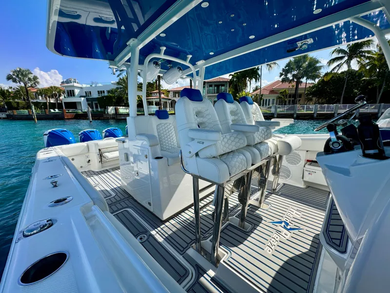 Slide: The Image of 2019 HCB 42 Siesta boat with luxurious seating and sleek design on a sunny waterfront. - 63