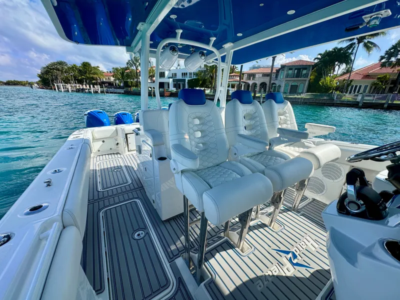 Slide: The Image of 2019 HCB 42 Siesta boat interior with luxurious seating and scenic waterfront view. - 68