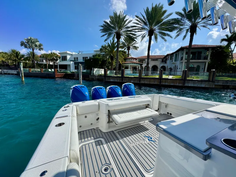 Slide: The Image of 2019 HCB 42 Siesta boat docked near luxury waterfront homes and palm trees. - 73