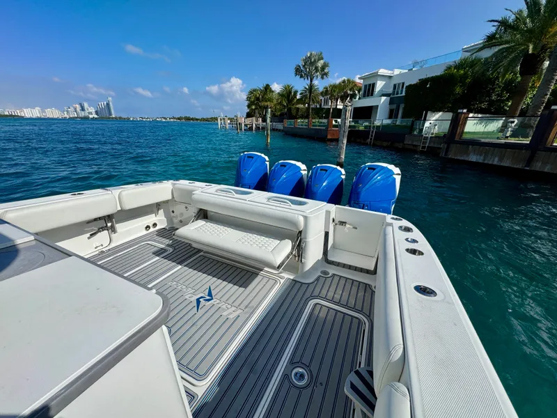 Slide: The Image of 2019 HCB 42 Siesta boat with four engines, docked near waterfront homes. - 75