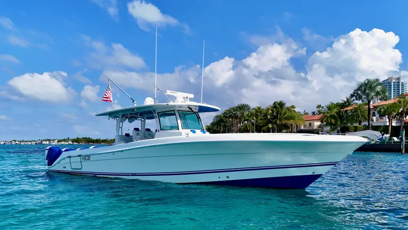 Slide: The Image of 2019 HCB 42 Siesta boat on clear blue water, under a sunny sky. - 8