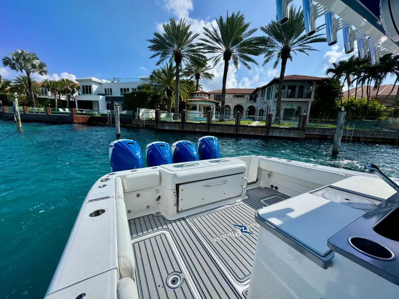 Slide: The Image of 2019 HCB 42 Siesta boat docked near luxury waterfront homes and palm trees. - 81