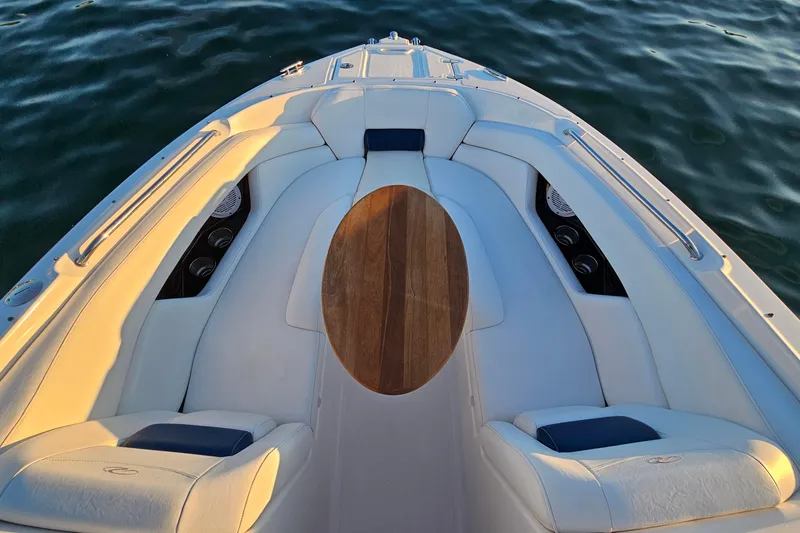 Slide: The Image of 2008 Regal 2700 ES Bowrider with elegant seating and wooden table on calm water. - 10
