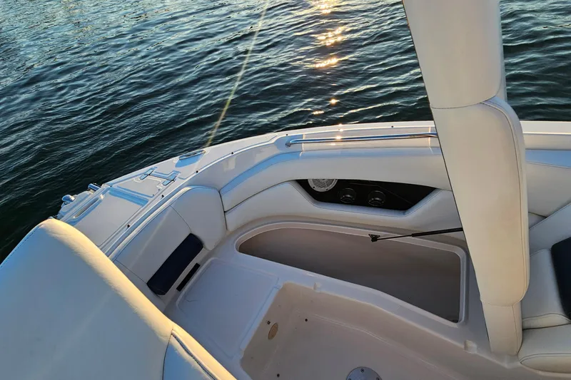 Slide: The Image of 2008 Regal 2700 ES Bowrider interior with white seating, on calm water. - 16