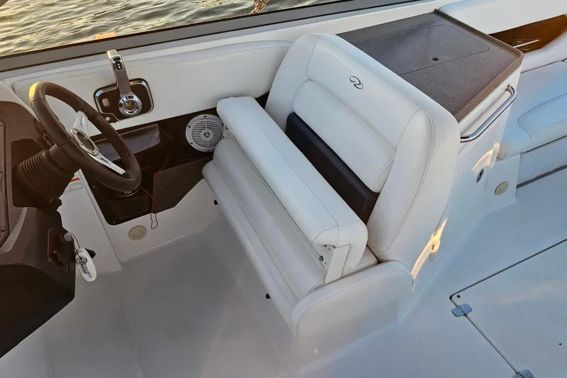 Slide: The Image of 2008 Regal 2700 ES Bowrider interior with white seating and steering wheel. - 29
