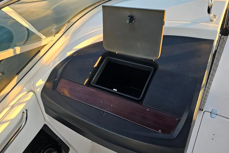 Slide: The Image of 2008 Regal 2700 ES Bowrider storage compartment with open lid, showcasing sleek design. - 35