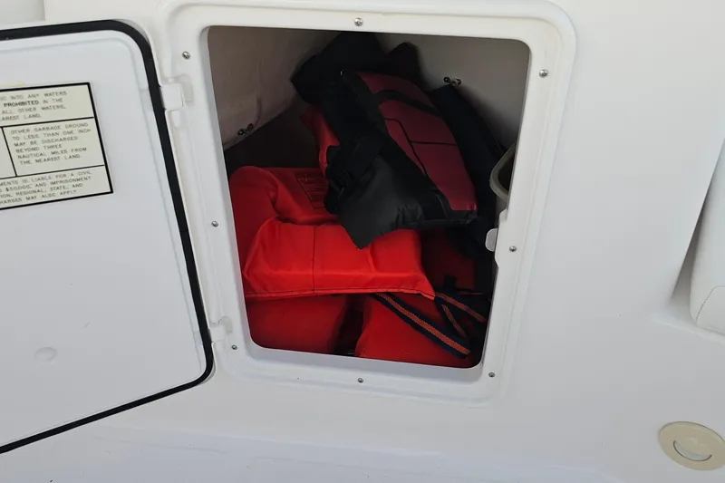Slide: The Image of Storage compartment with life jackets on a 2008 Regal 2700 ES Bowrider boat. - 39
